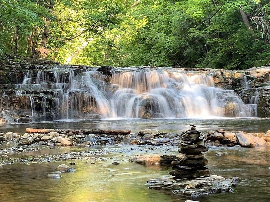 Great Gully wide, stout waterfall. Lush greenery in the background